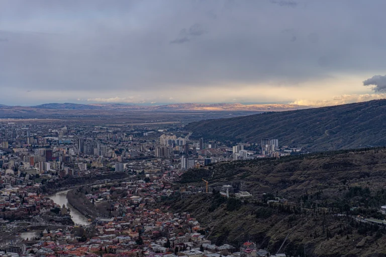 Breathtaking panoramic view overlooking the cityscape of Tbilisi, Georgia, from the Mtatsminda viewpoint, showcasing the city's landmarks and layout. Cityscape photography by Georgian artist Zurab Kostava.