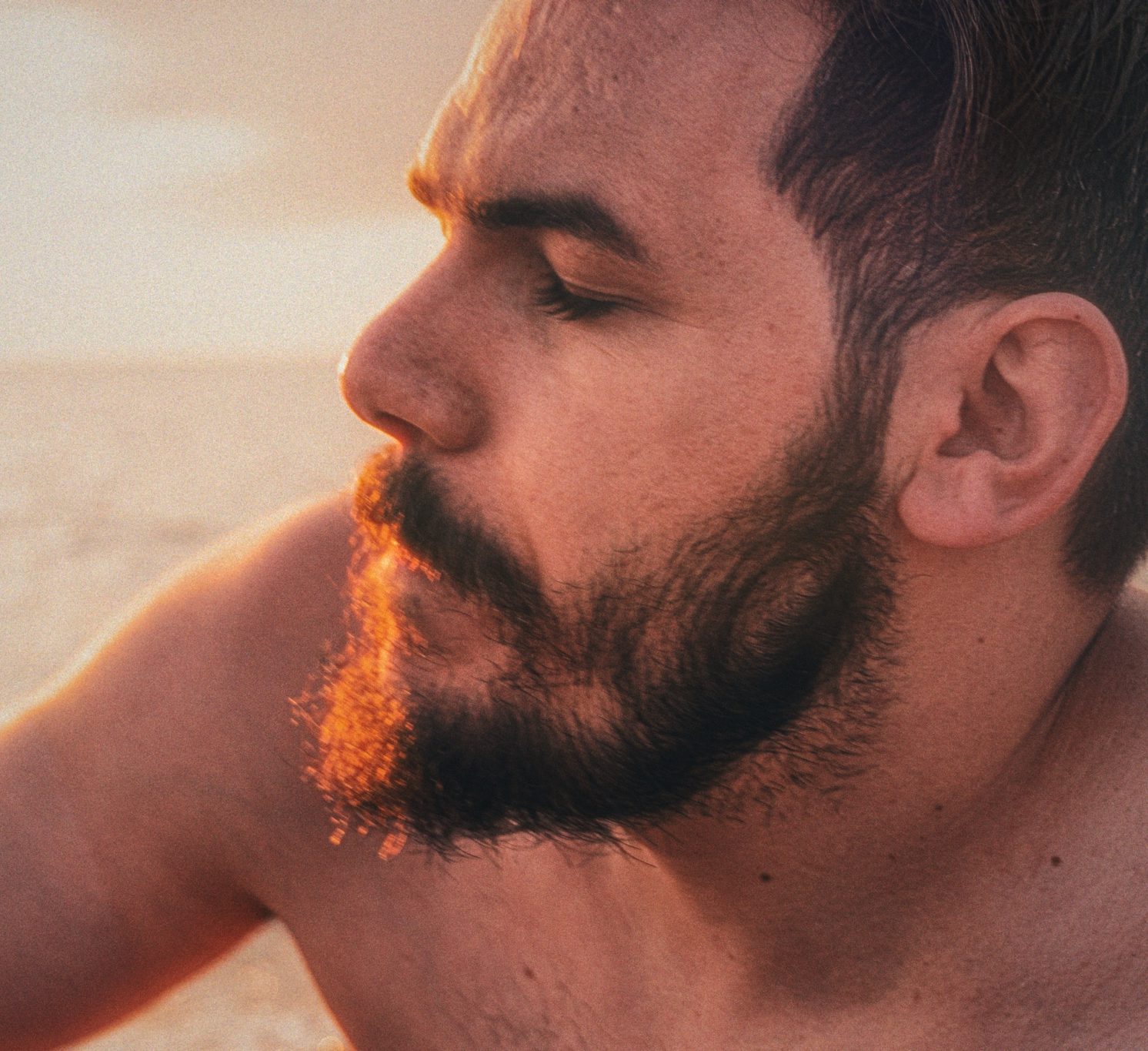 Artistic profile portrait of Zurab Kostava, Georgian artist and explorer, in golden hour sunlight.